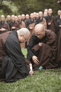 At the burial ceremony, Abbott President of DDM Master Guodong plants Master Sheng Yen’s ashes into the ground at Dharma Drum Mountain Green Life Park, New Taipei City, Taiwan.